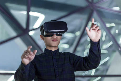 Man wearing virtual reality simulator outdoors.